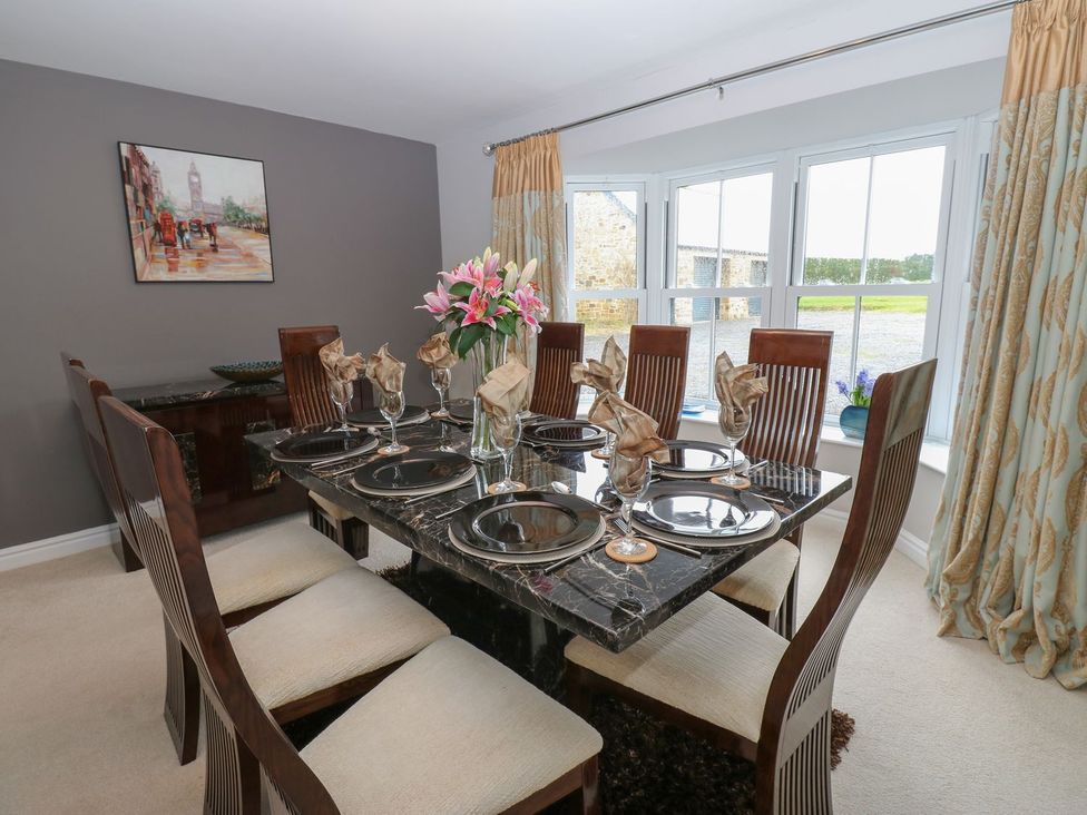 A dining room with a table set for dinner at Hollymoor Hall Farm in Richmond