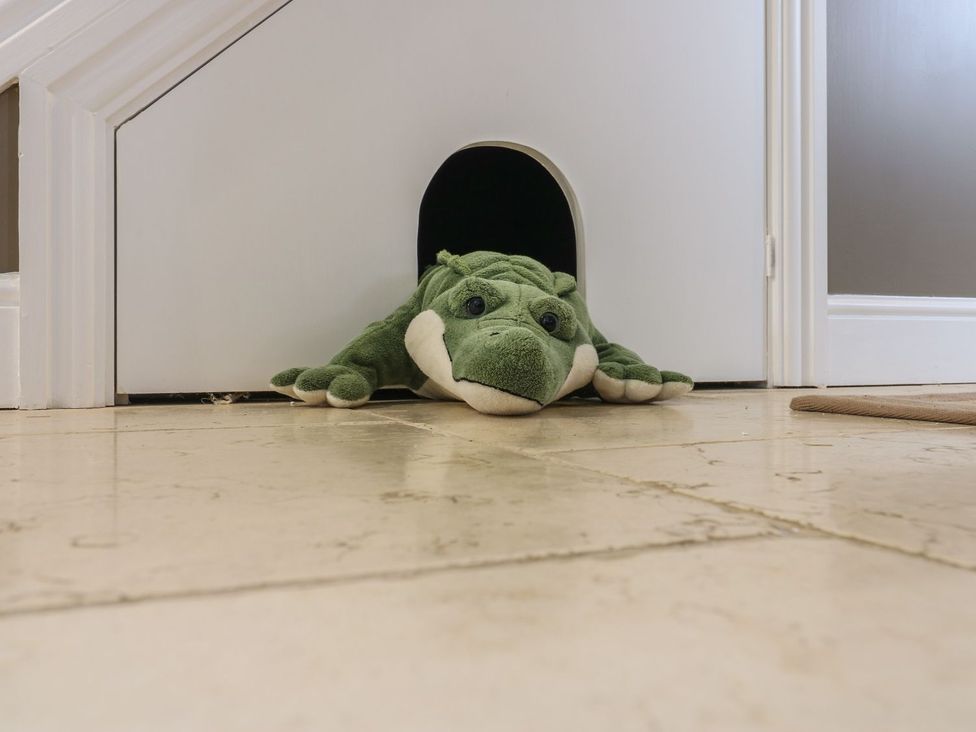A green stuffed toy at the doorway of a room at Hollymoor Hall Farm Richmond