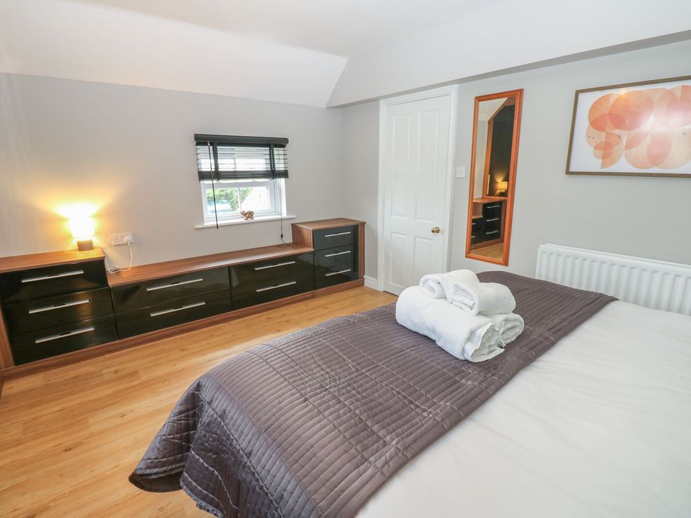 A bedroom with a bed and dresser at Hollymoor Hall Farm in Richmond