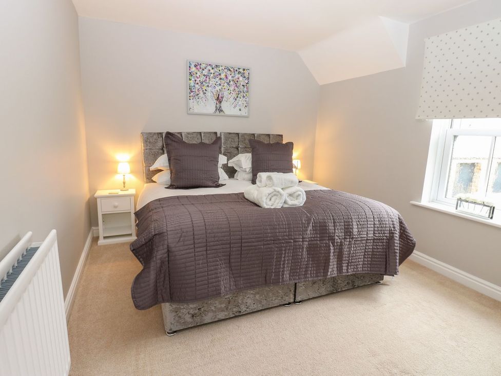 A bedroom with a bed and nightstand at Hollymoor Hall Farm in Richmond