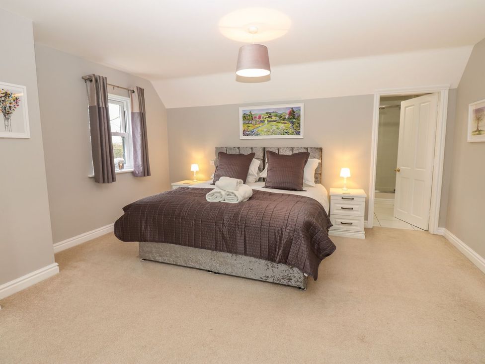 A bedroom with a bed and bedside tables at Hollymoor Hall Farm in Richmond