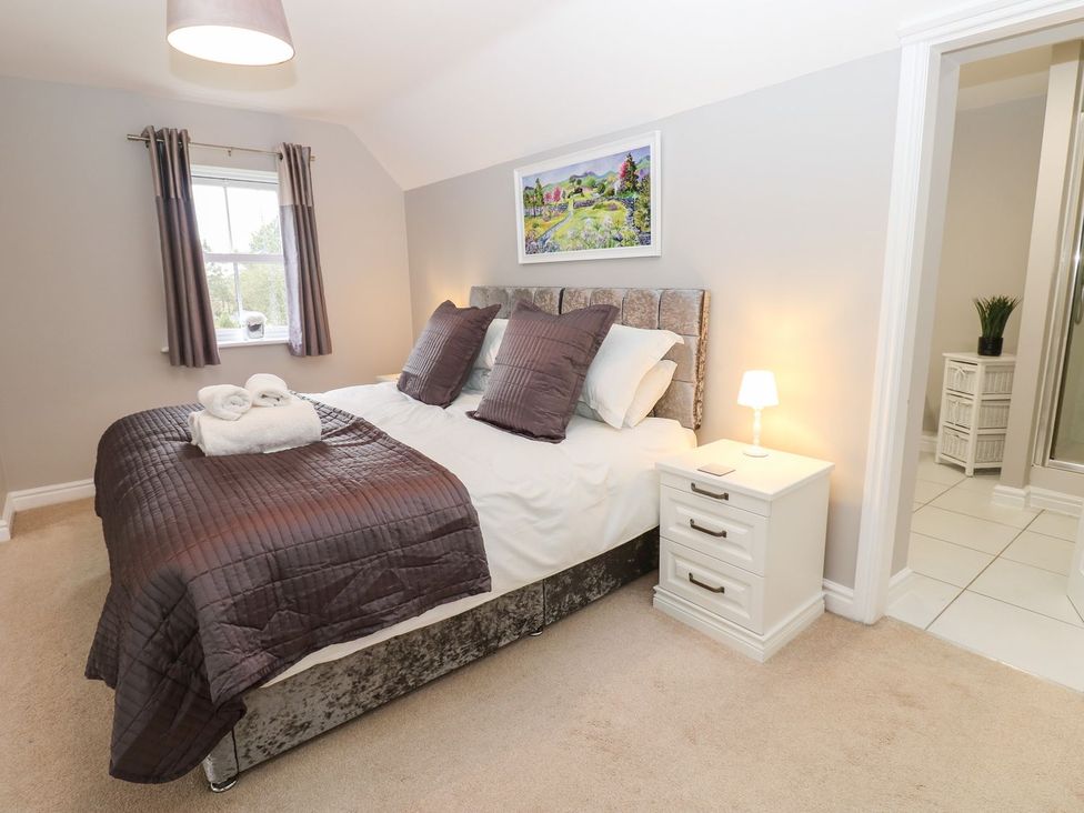 A bedroom with a bed and bedside table at Hollymoor Hall Farm in Richmond