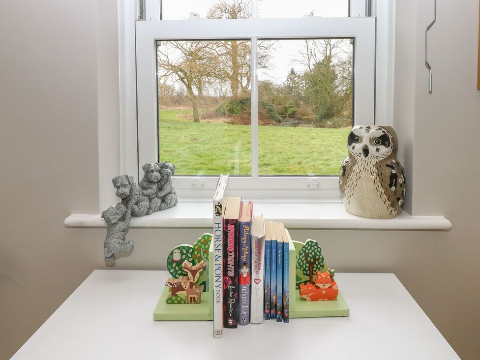 A window with books and figurines at Hollymoor Hall Farm in Richmond