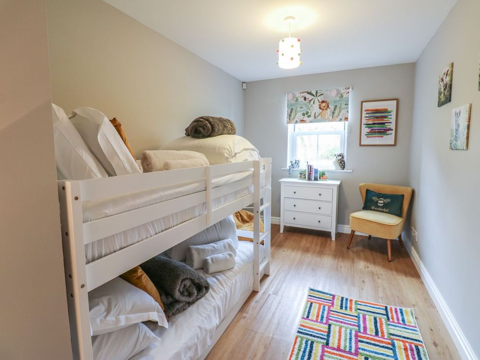 A bedroom with a bunk bed and a dresser at Hollymoor Hall Farm in Richmond