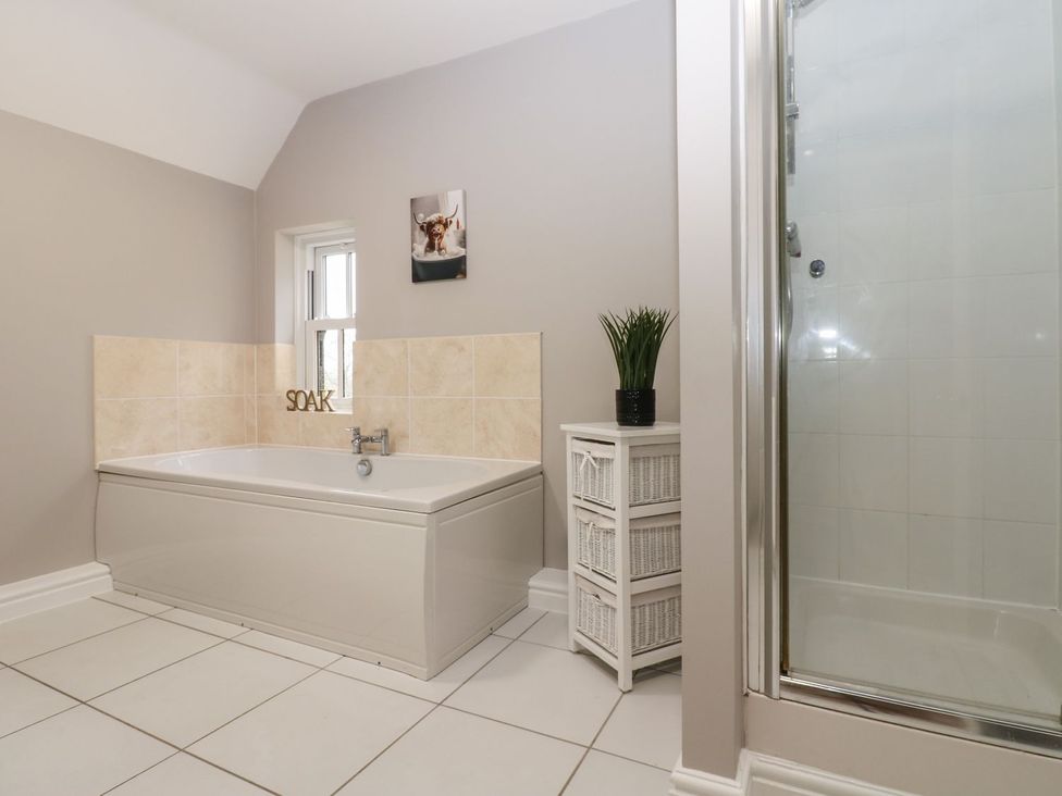A bathroom with a bathtub and shower at Hollymoor Hall Farm in Richmond