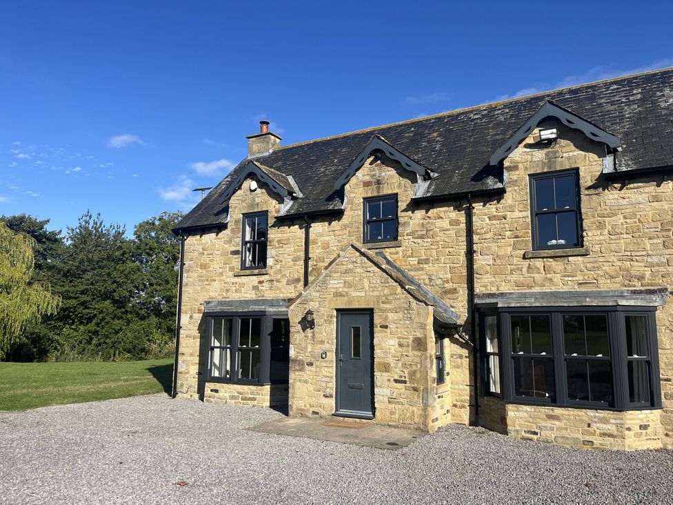 A house with stone exterior and gravel driveway at Hollymoor Hall Farm Richmond