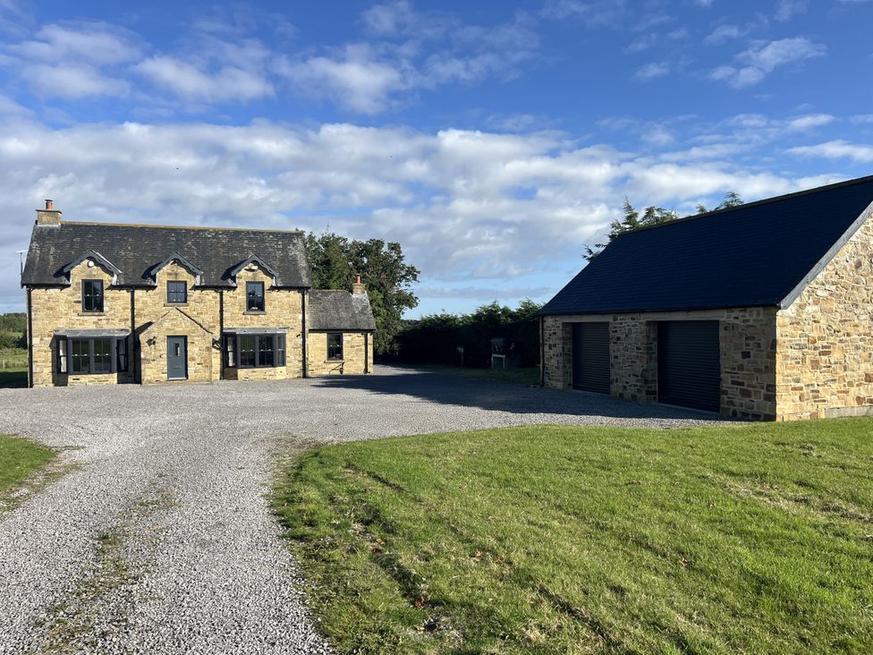 A house with a garage and gravel driveway at Hollymoor Hall Farm Richmond