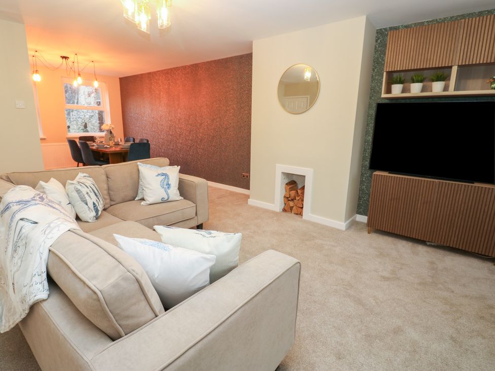 A living room with a sofa and television at 11 North Terrace Seaham