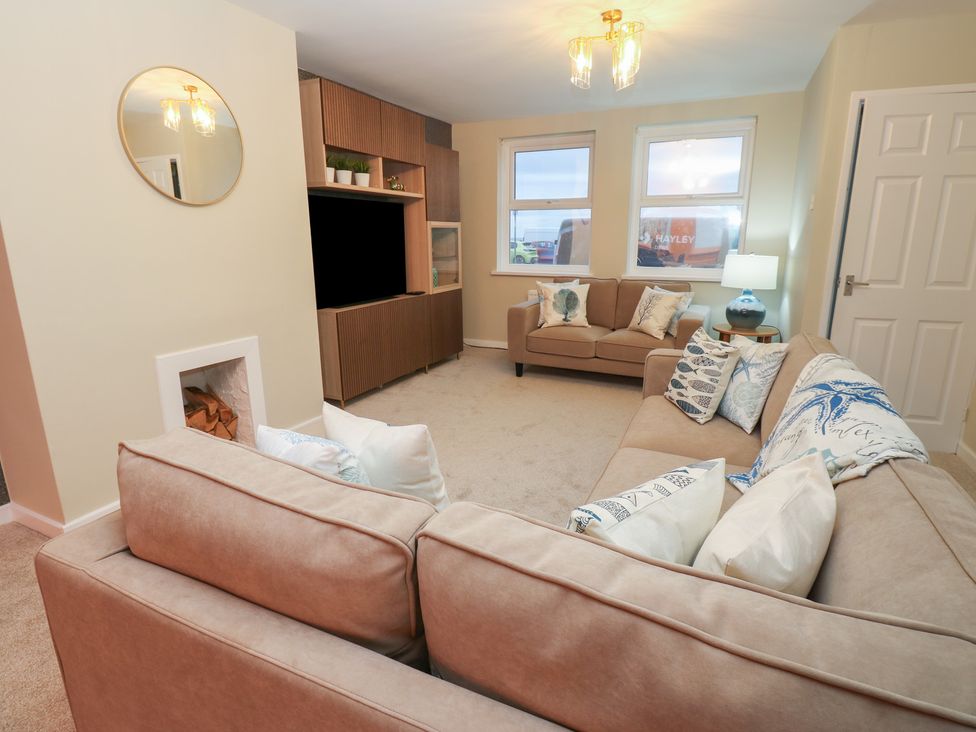 A living room with sofas and a television unit at 11 North Terrace in Seaham