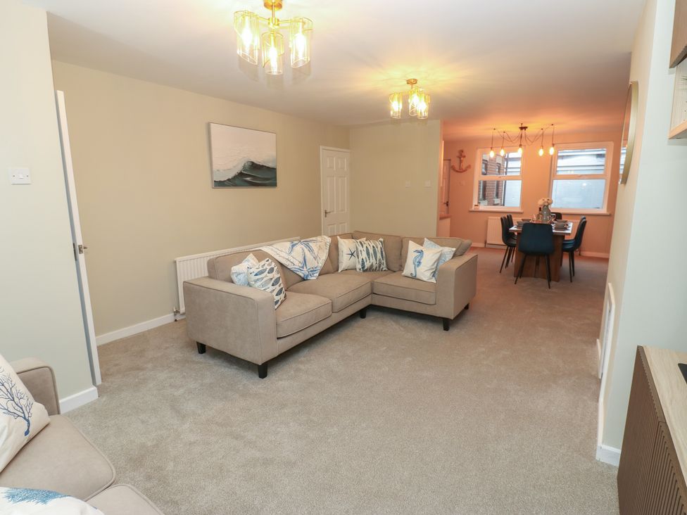 A living room with a sofa and a dining area at 11 North Terrace in Seaham