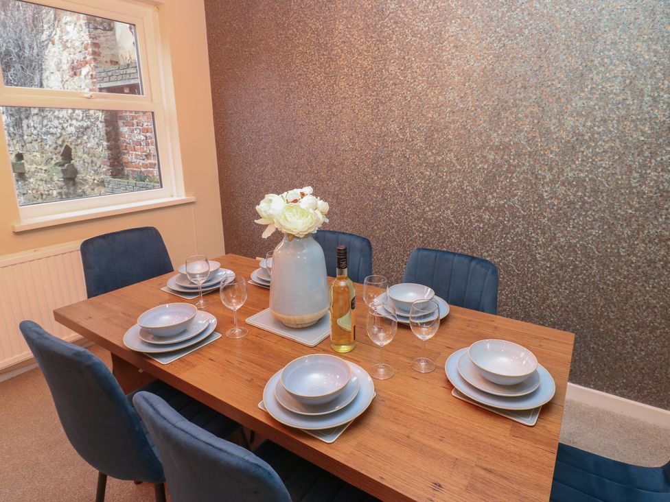 A dining room with a table set for a meal at 11 North Terrace in Seaham