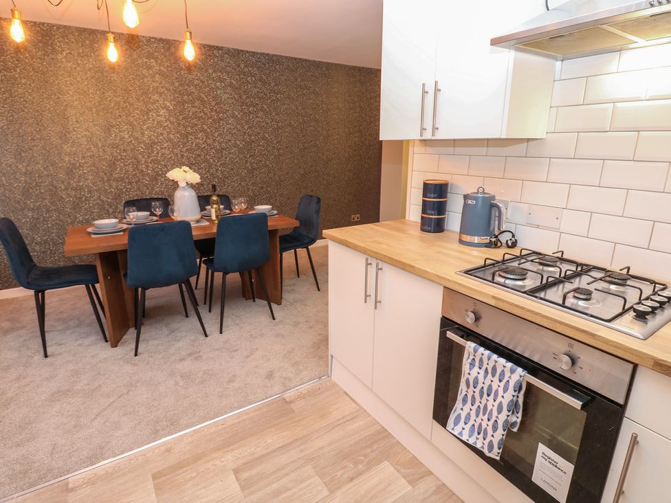 A dining room with a table and chairs at 11 North Terrace in Seaham