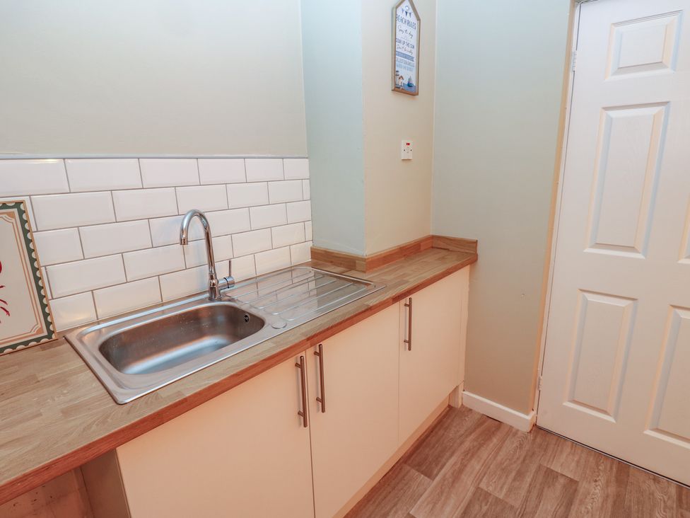 A kitchen with a sink and countertop at 11 North Terrace in Seaham