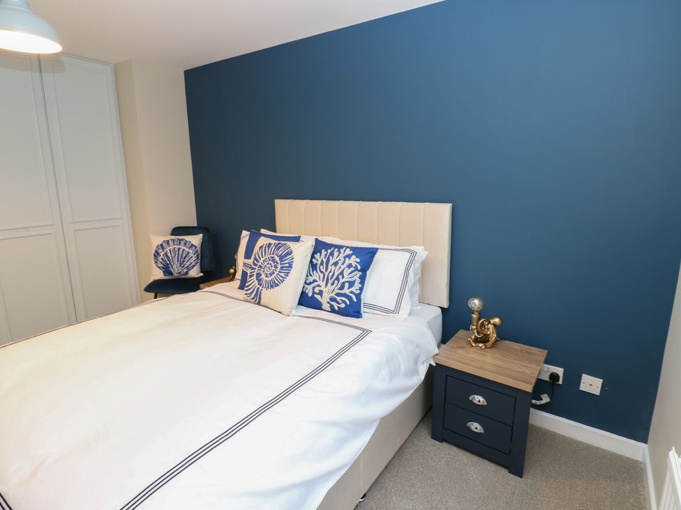 A bedroom with a bed and side table at 11 North Terrace in Seaham