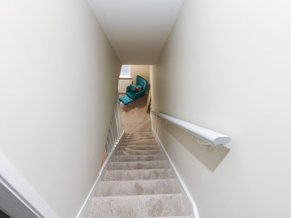 A staircase leading down to an armchair at 11 North Terrace in Seaham