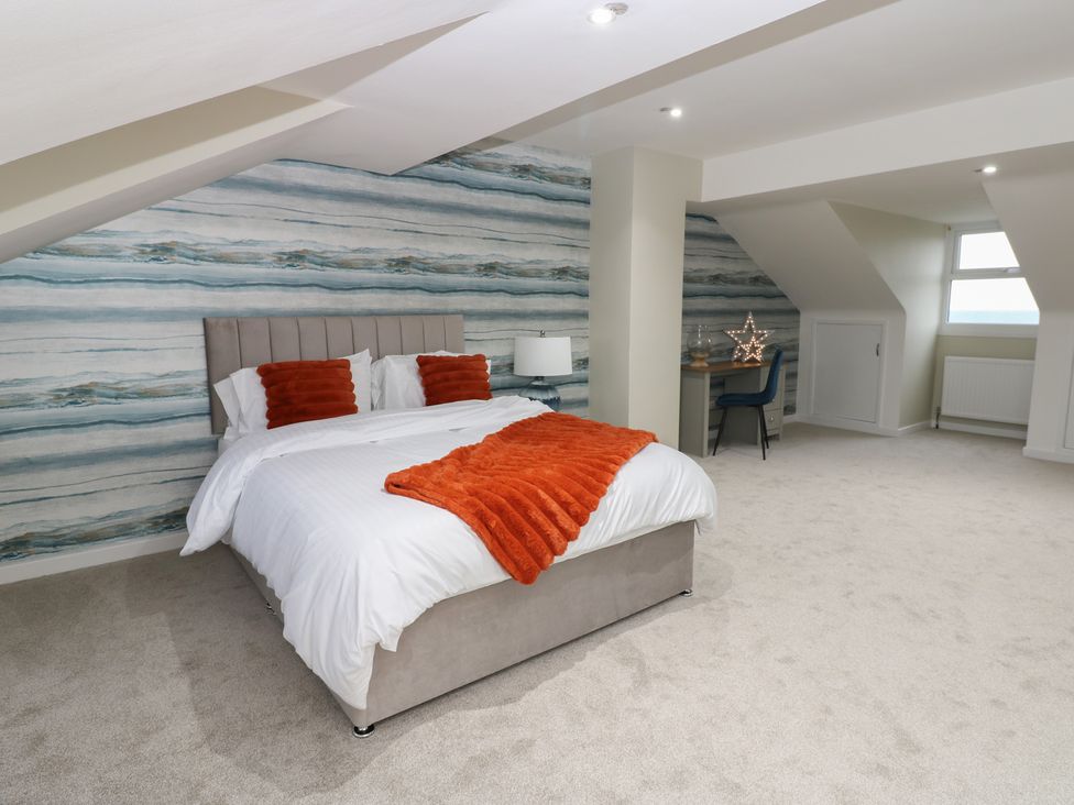A bedroom with a bed and desk at 11 North Terrace in Seaham