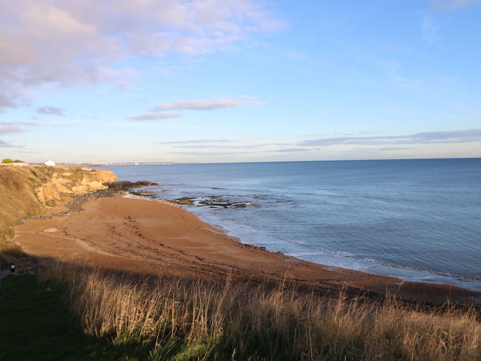 A beach with sand and an ocean view at 11 North Terrace in Seaham