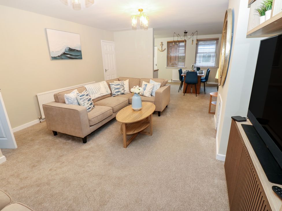 A living room with a sofa and coffee table at Eleven Tides in Seaham