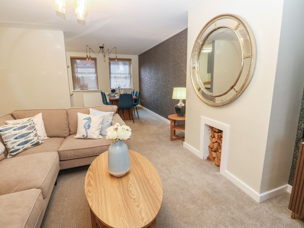 A living room with seating and dining area at Eleven Tides in Seaham