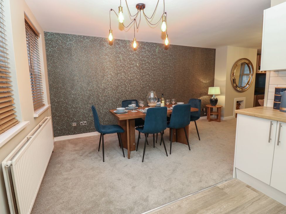 A dining room with a table and chairs at Eleven Tides in Seaham