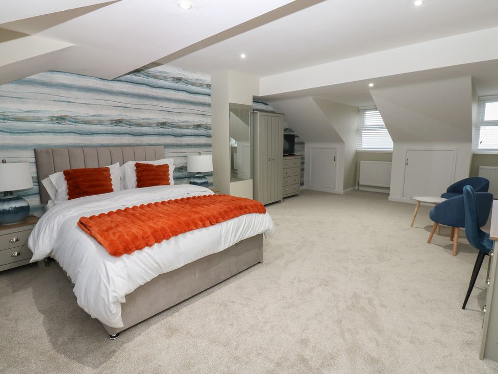 A bedroom with a bed and furniture at Eleven Tides in Seaham