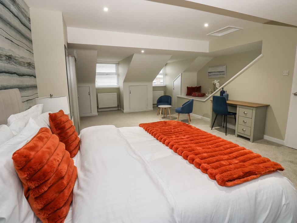 A bedroom with a bed and desk at Eleven Tides in Seaham