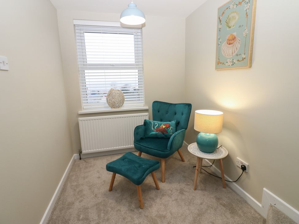 A snug with a chair and lamp at Eleven Tides in Seaham