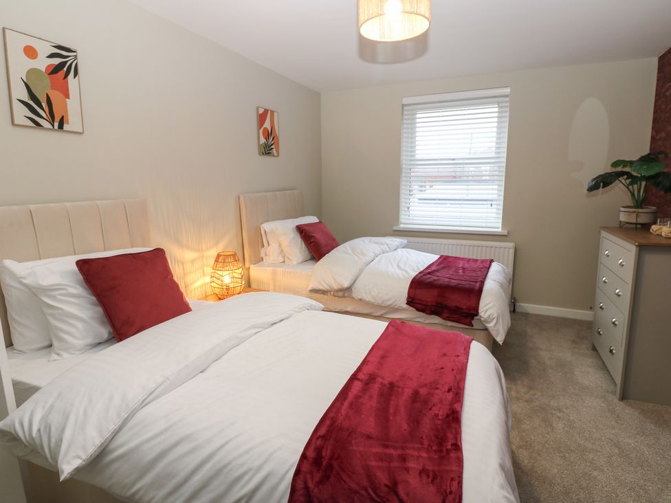 A bedroom with two beds and a chest of drawers at Eleven Tides in Seaham