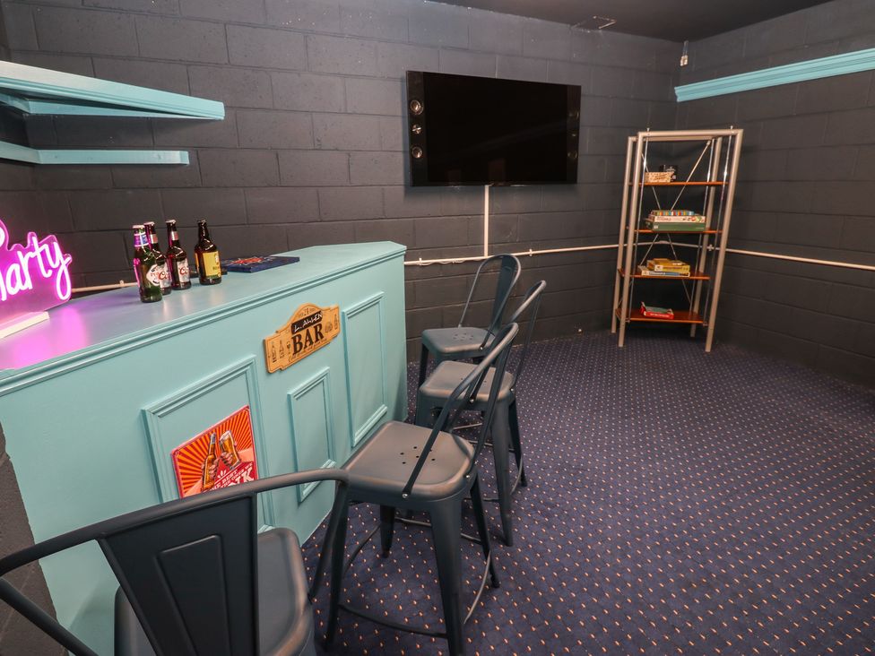 A snug area with a bar and stools at Eleven Tides in Seaham
