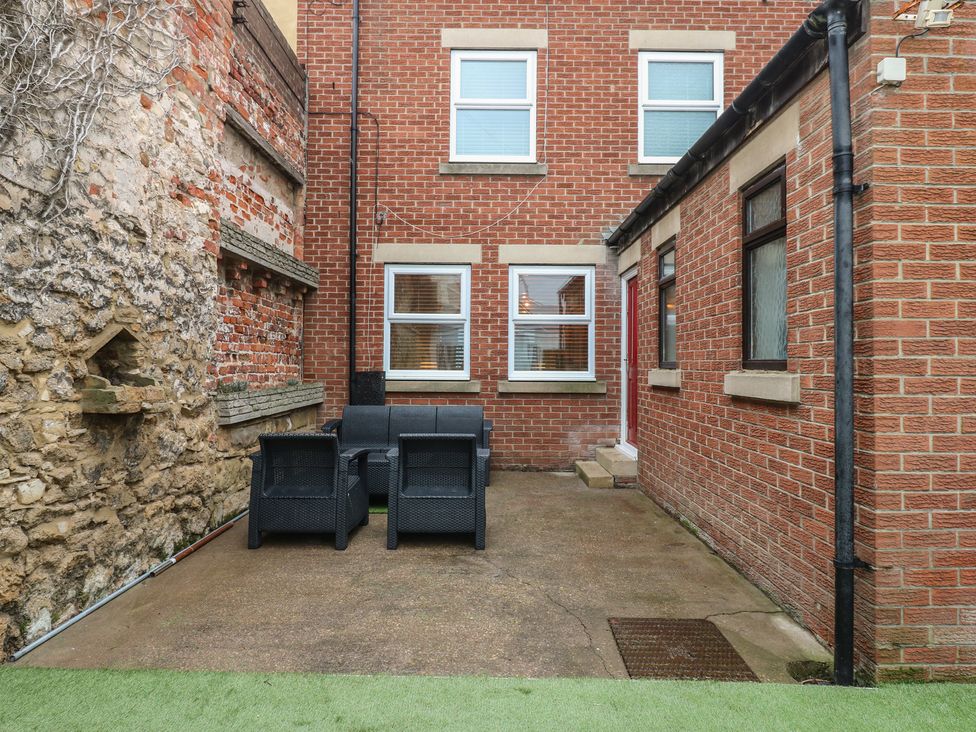 An outdoor area with chairs and windows at Eleven Tides in Seaham