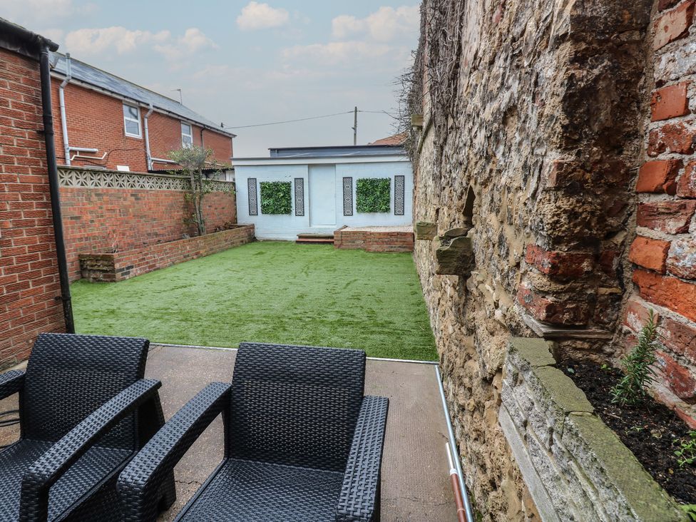 A garden with artificial grass and chairs at Eleven Tides in Seaham