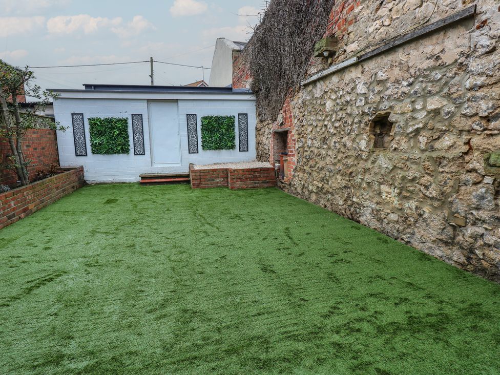 A garden with artificial grass and decorative panels at Eleven Tides in Seaham