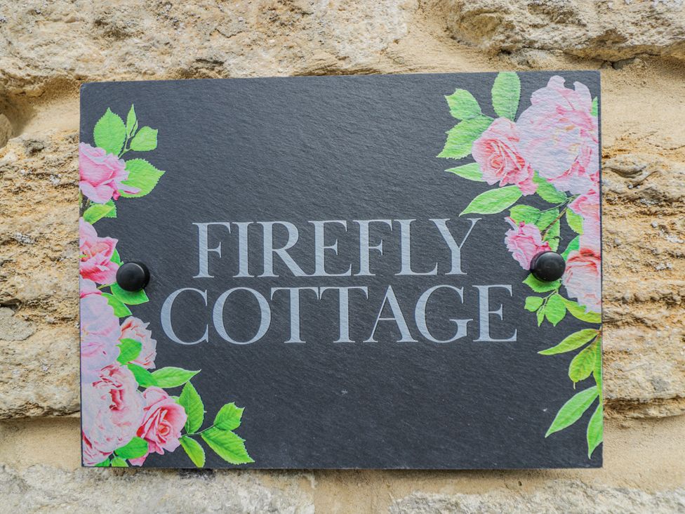 A sign with the name Firefly Cottage at Firefly Cottage