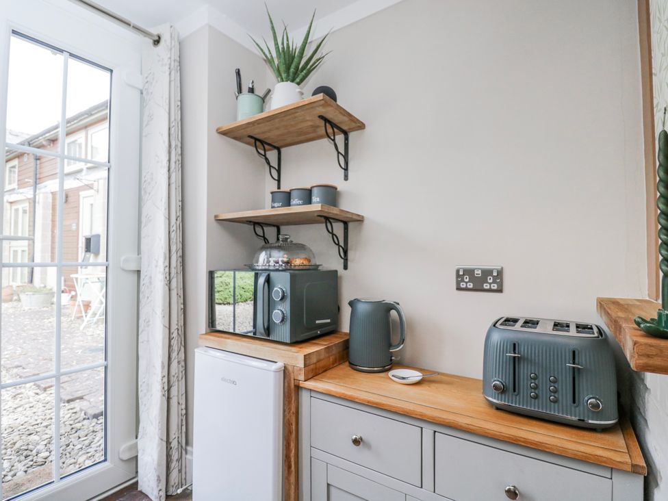 A kitchen with a kettle and toaster at Firefly Cottage