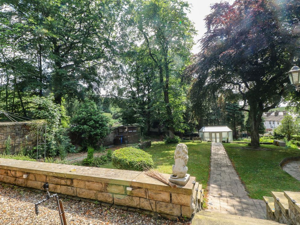 A garden with trees and a pathway at Stone House Rossendale