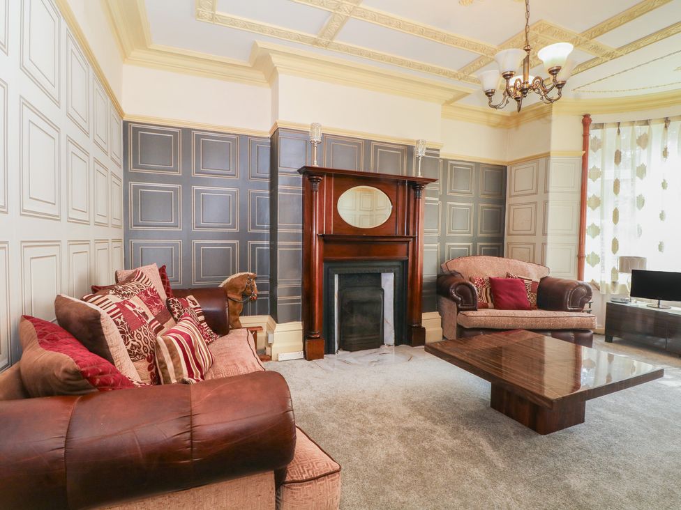 A living room with a fireplace and coffee table at Stone House in Rossendale