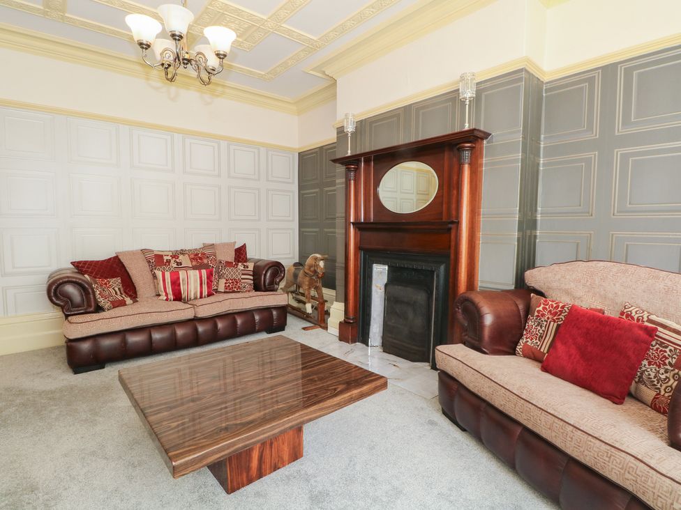 A living room with sofas and a fireplace at Stone House in Rossendale