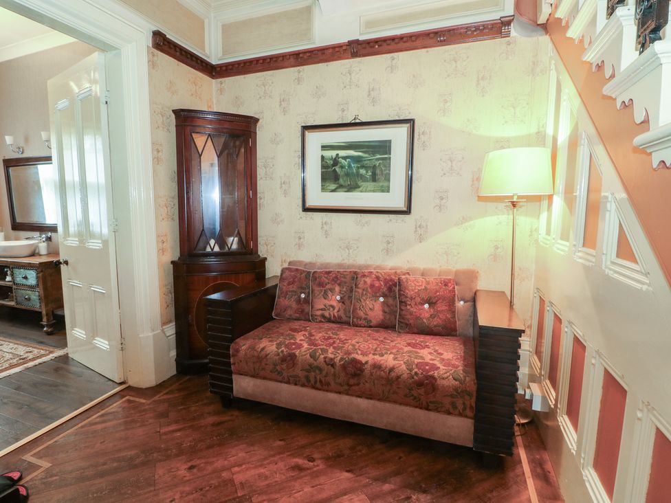 A living room with a sofa and lamp at Stone House in Rossendale