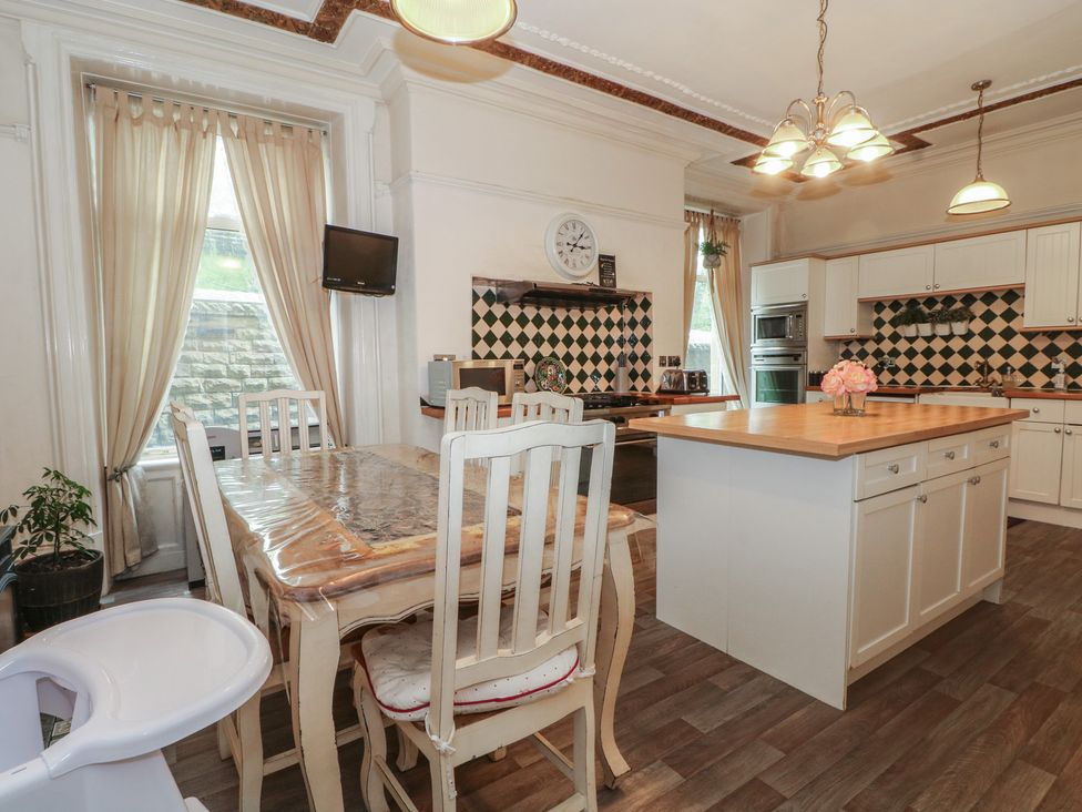 A kitchen with a dining table and chairs at Stone House in Rossendale
