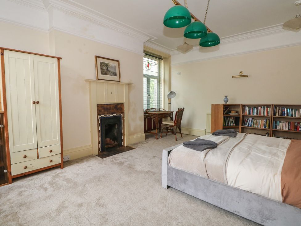 A bedroom with a bed and a bookshelf at Stone House in Rossendale