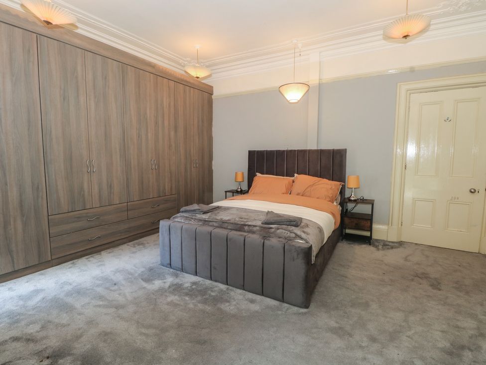 A bedroom with a bed and wardrobe at Stone House in Rossendale