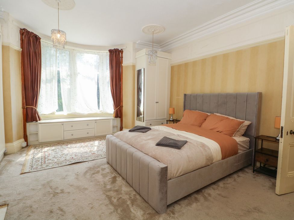 A bedroom with a bed and furniture at Stone House in Rossendale
