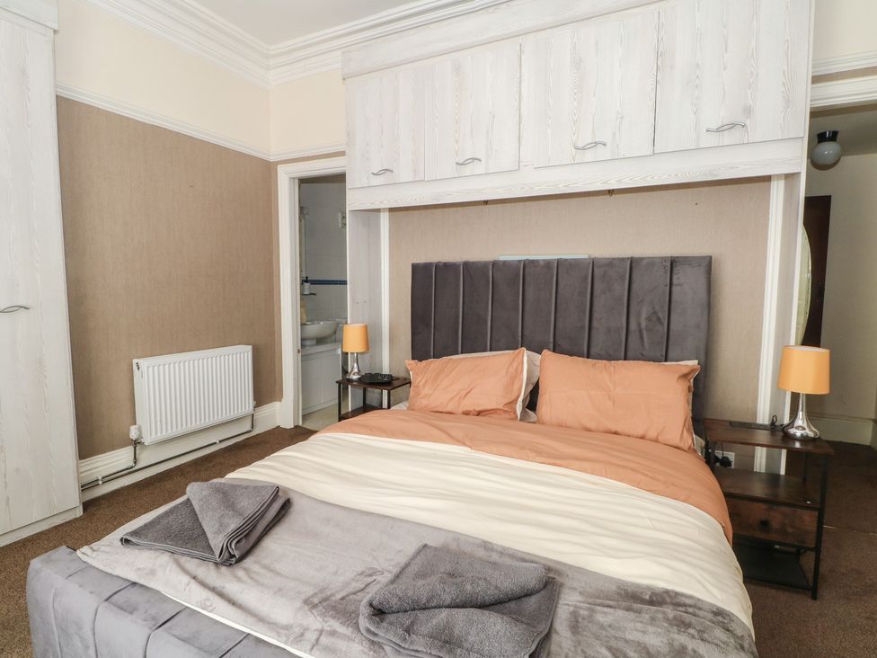 A bedroom with a bed and bedside table at Stone House in Rossendale