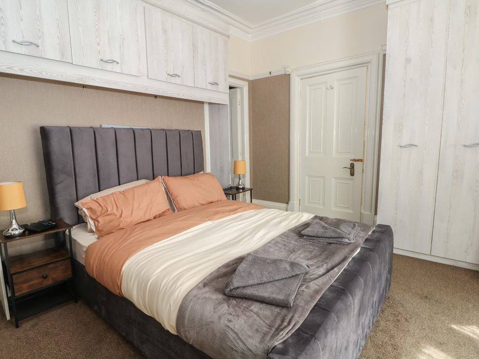 A bedroom with a bed and nightstand at Stone House in Rossendale