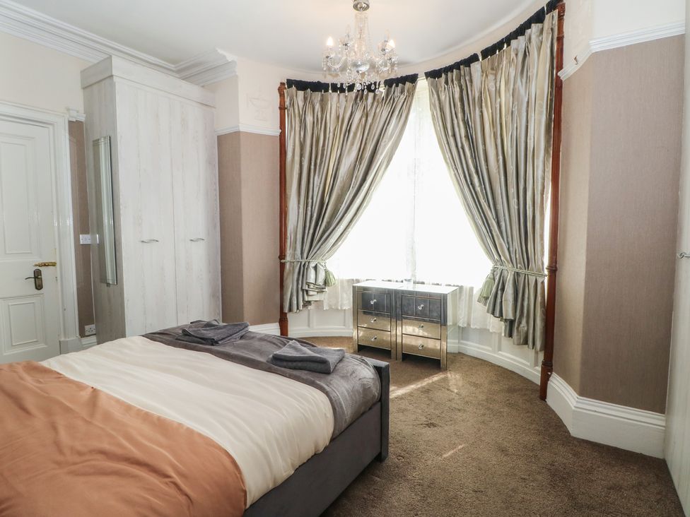 A bedroom with a bed and wardrobe at Stone House in Rossendale