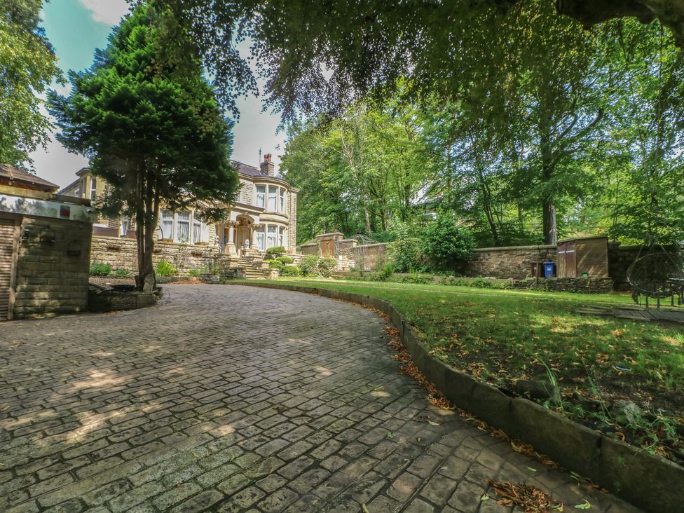 A house with a garden and paved driveway at Stone House in Rossendale