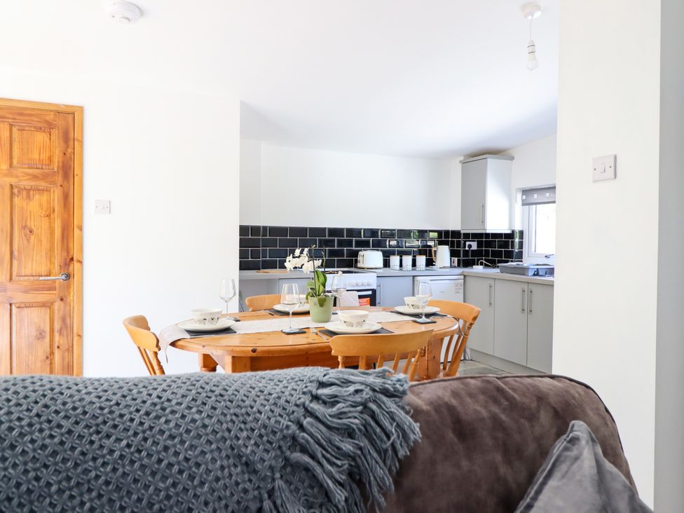 A dining room with a table and chairs at Haven in Lloc near Holywell