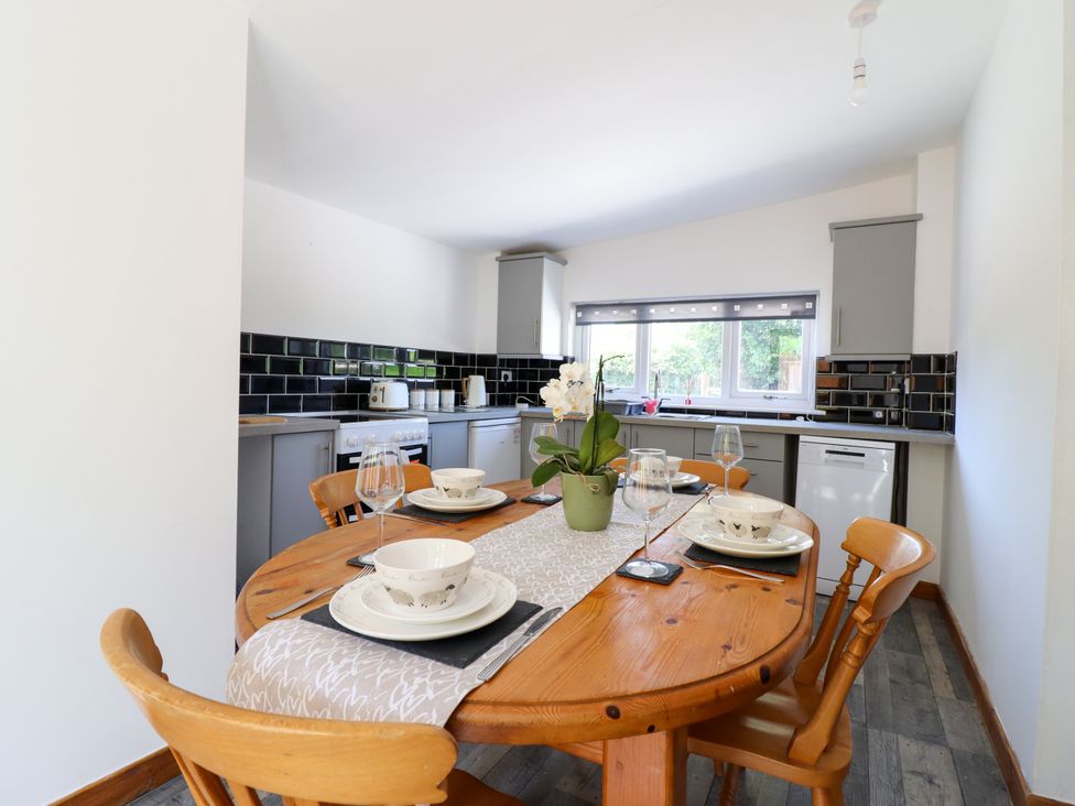 A dining room with a table set for a meal at Haven in Lloc near Holywell