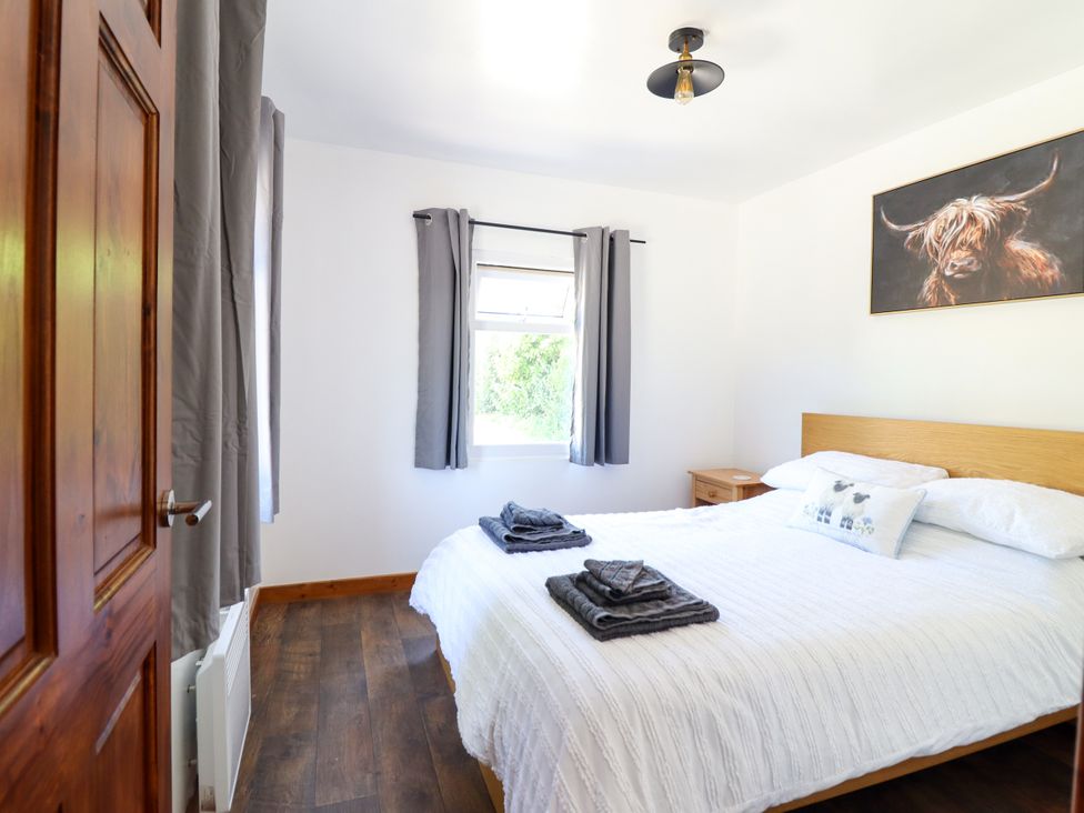 A bedroom with a bed and window at Haven in Lloc near Holywell