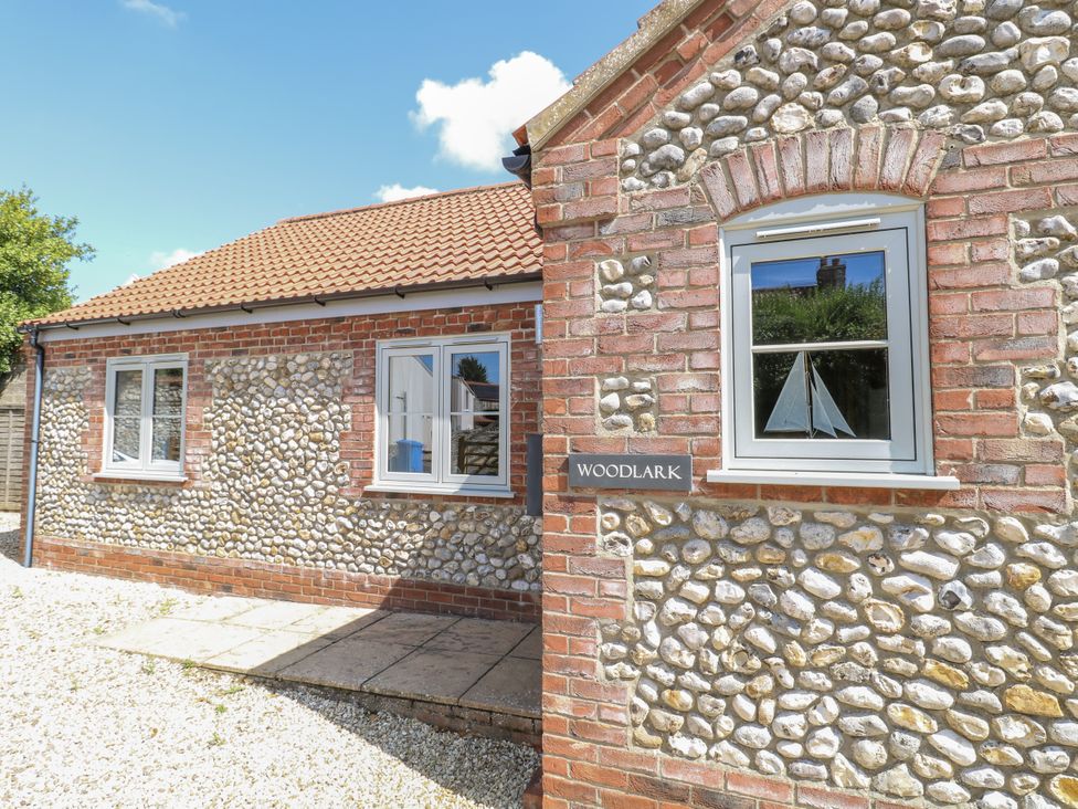 A house with a pathway and windows at Woodlark